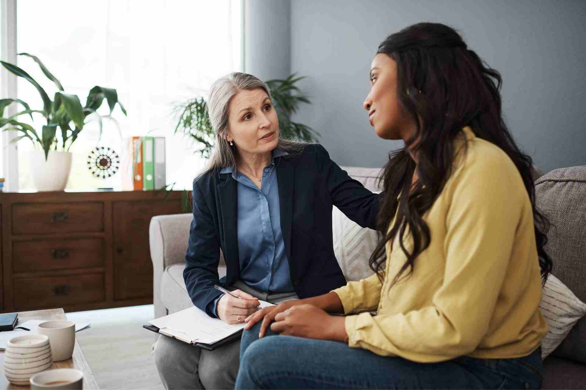 Licensed mental health therapist providing one-on-one counseling to an adult woman during an individual therapy session.
