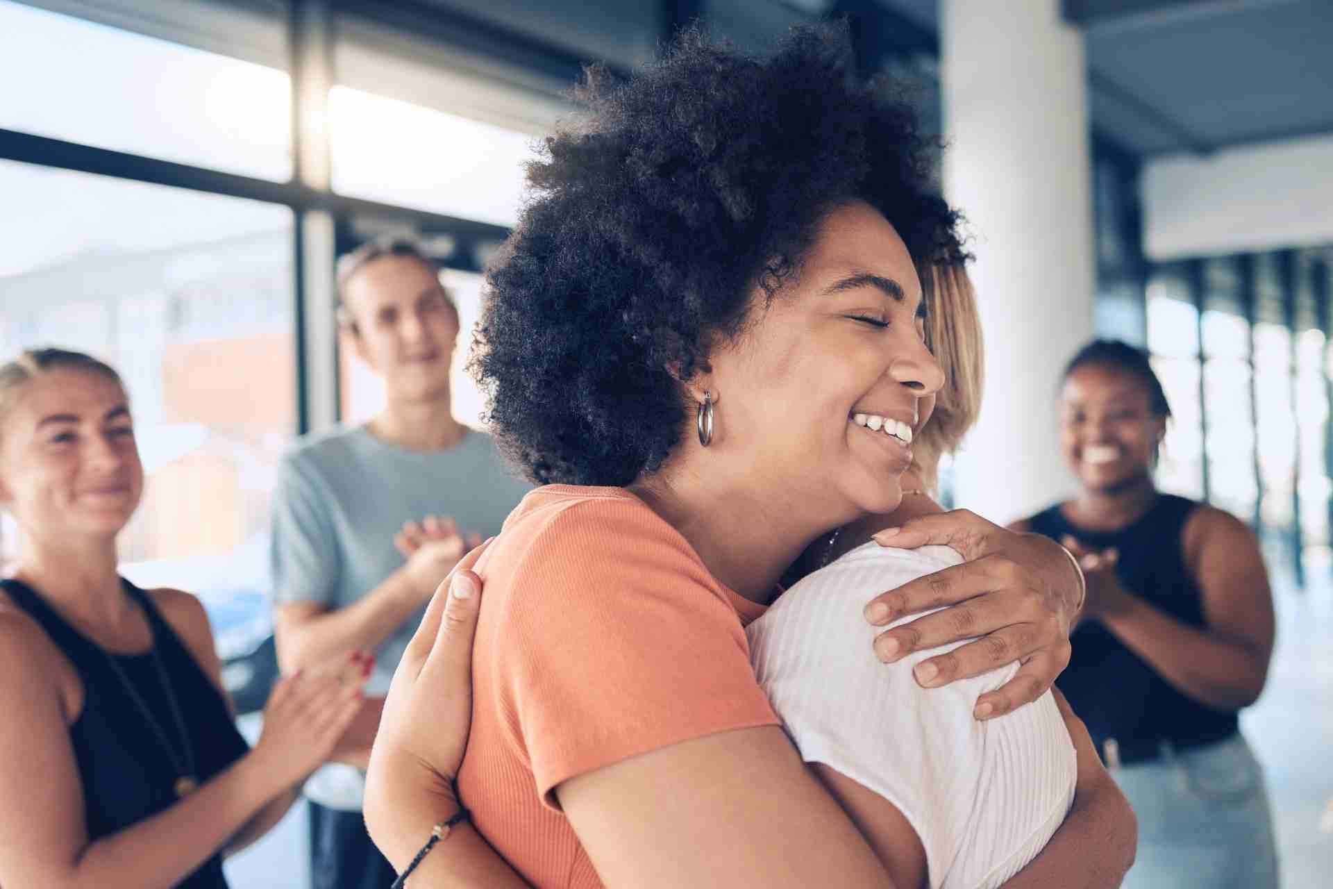 Person embracing another participant after an EMDR therapy session for trauma recovery.