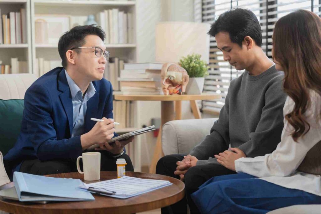 A therapist meets with a couple during a Dialectical Behavior Therapy (DBT) session, discussing emotional regulation, healthy coping skills, and relationship support.