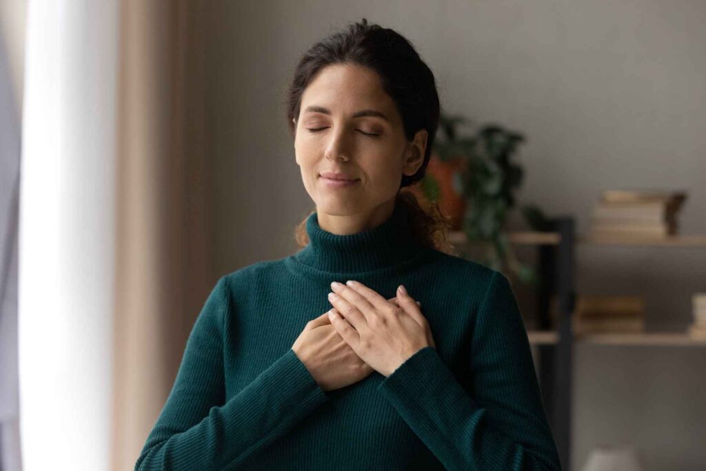 Woman practicing a calming technique to manage intense emotions
