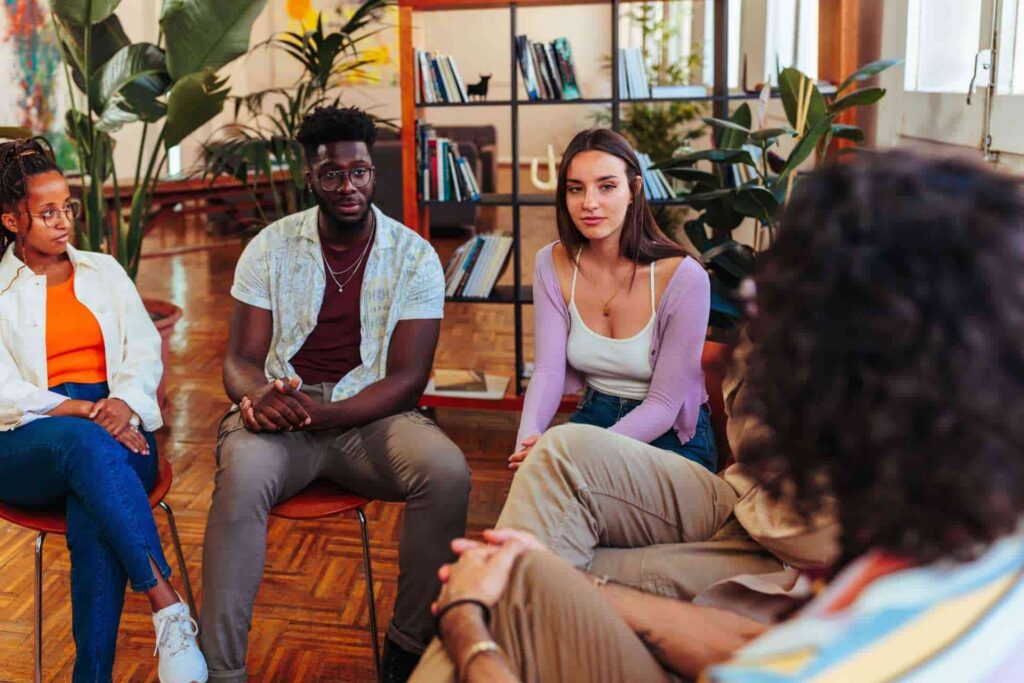 Adults participating in group therapy for trauma recovery and mental health
