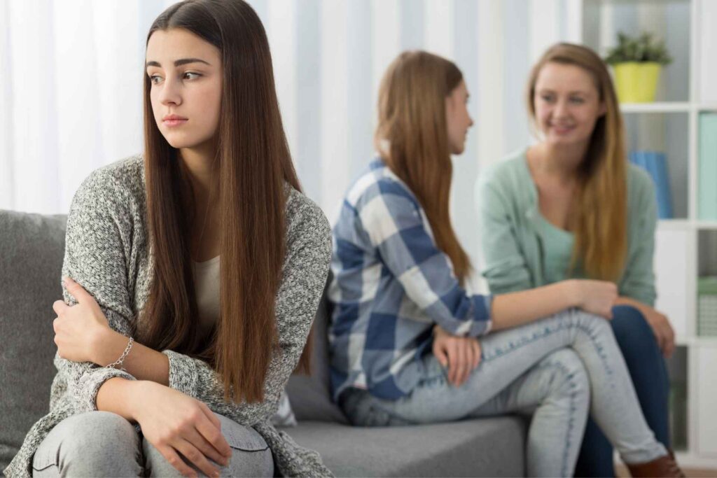 Young woman feeling left out during a social interaction