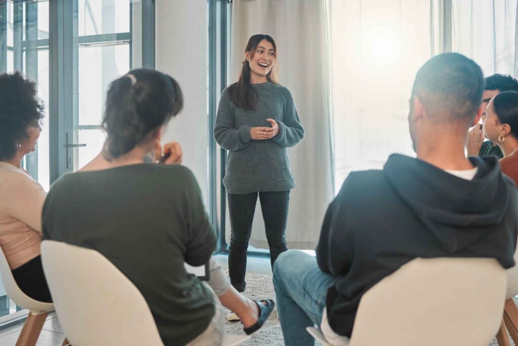 Therapist leading a group therapy session for mental health support.